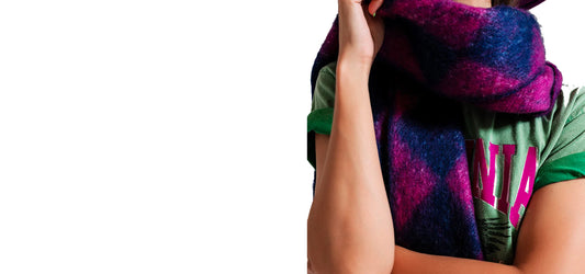  A model draped in the shades of 2023's Fall and Winter - Plush Purple, Vivacious Violet, and Kinetic Kelly Green.